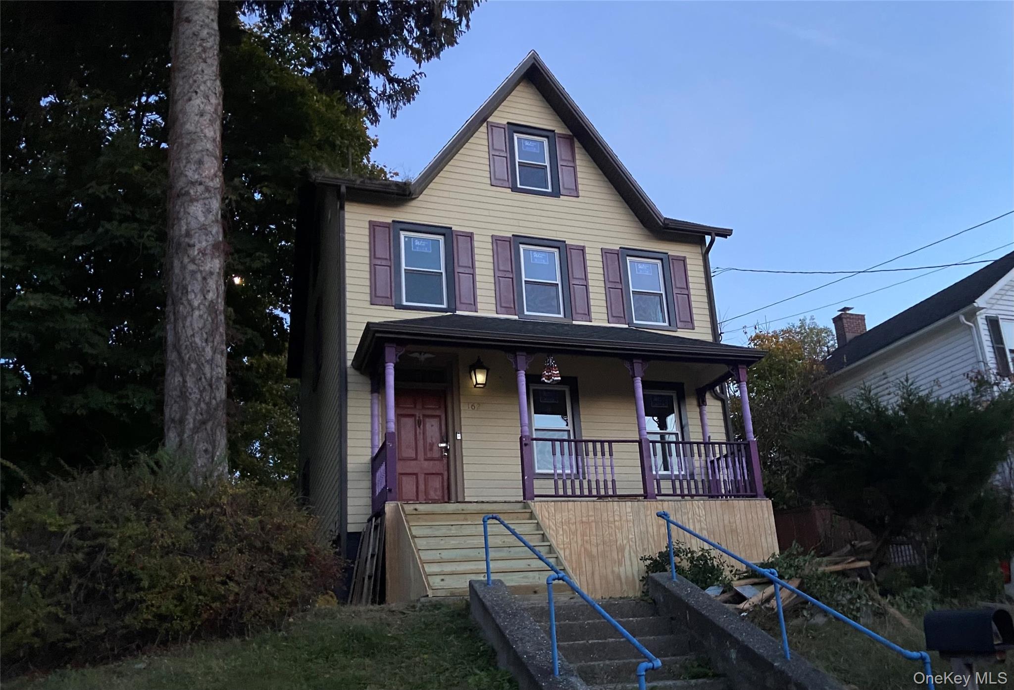 View of front of home with covered porch and stairs