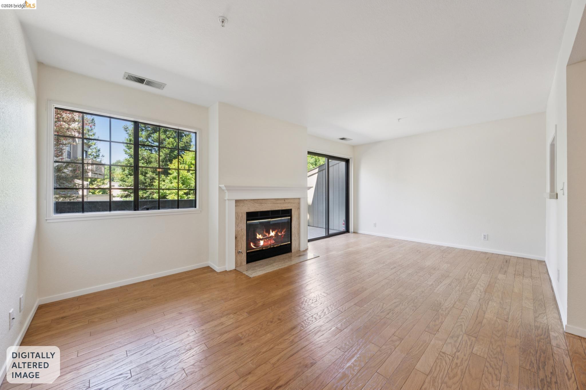 261 Redhawk Road Novato, CA 94949 - Photo 12 of 44 Spacious interior featuring wood-finish flooring, a contemporary fireplace with a stone surround and white mantel, a large window with black gridding, a sliding glass door, and neutral-toned walls