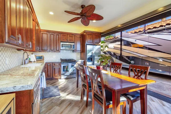 a view of a dining room with furniture and a kitchen