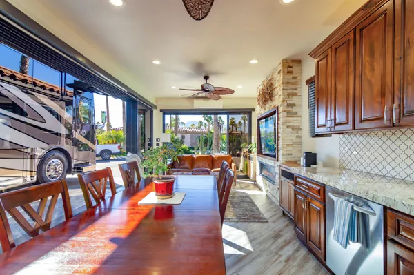 a very nice looking living room with kitchen and furniture