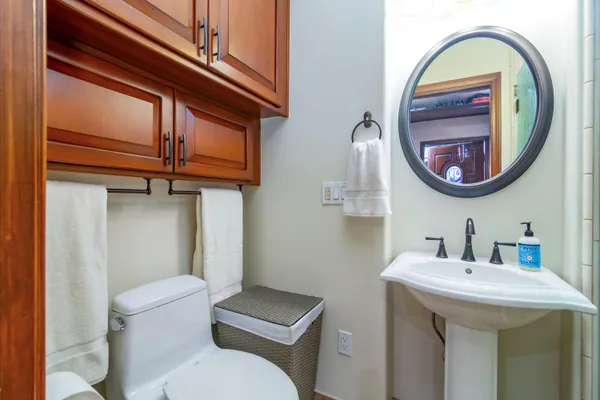 a bathroom with a toilet a sink and a mirror