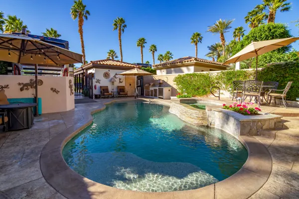 a backyard of a house with outdoor seating