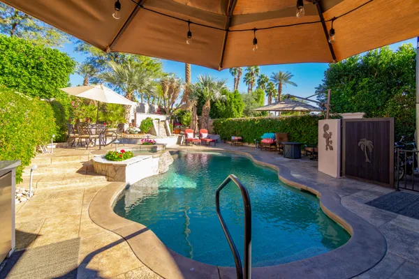 a backyard of a house with outdoor seating