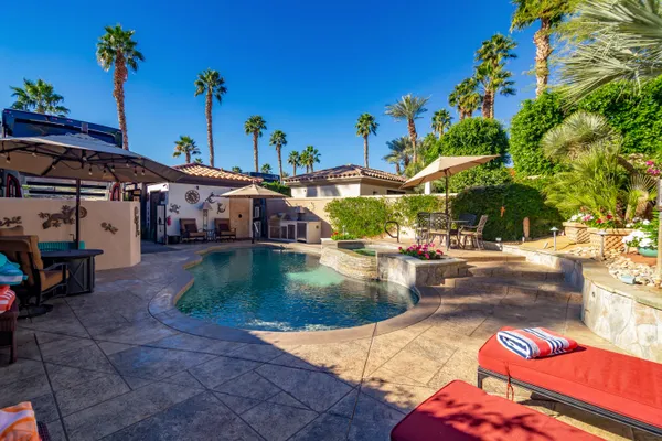 a living room with lots of furniture and a view of kitchen