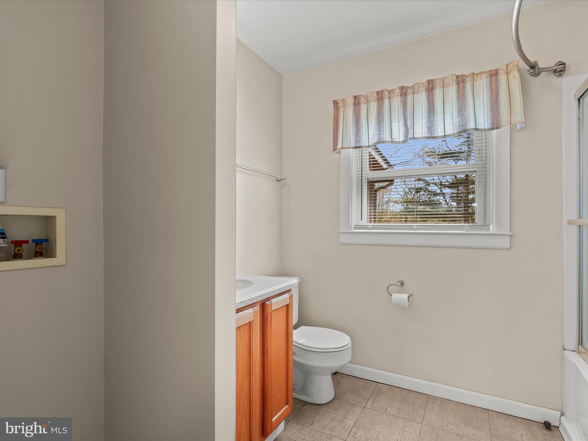 9151 Riverhill Road Laurel, MD 20723 - Photo 18 of 41 a white toilet sitting next to a bathroom sink