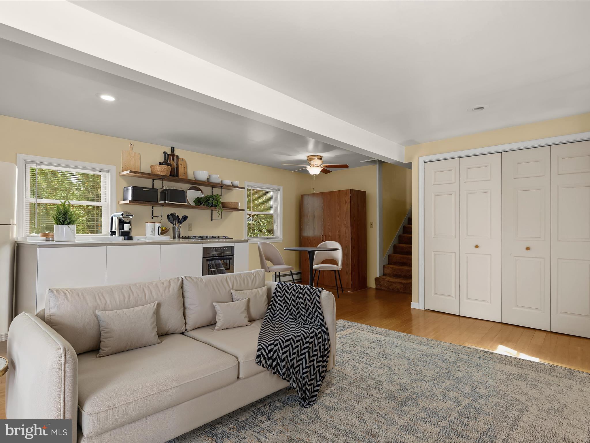 9151 Riverhill Road Laurel, MD 20723 - Photo 4 of 41 a living room with furniture a fireplace and a large window