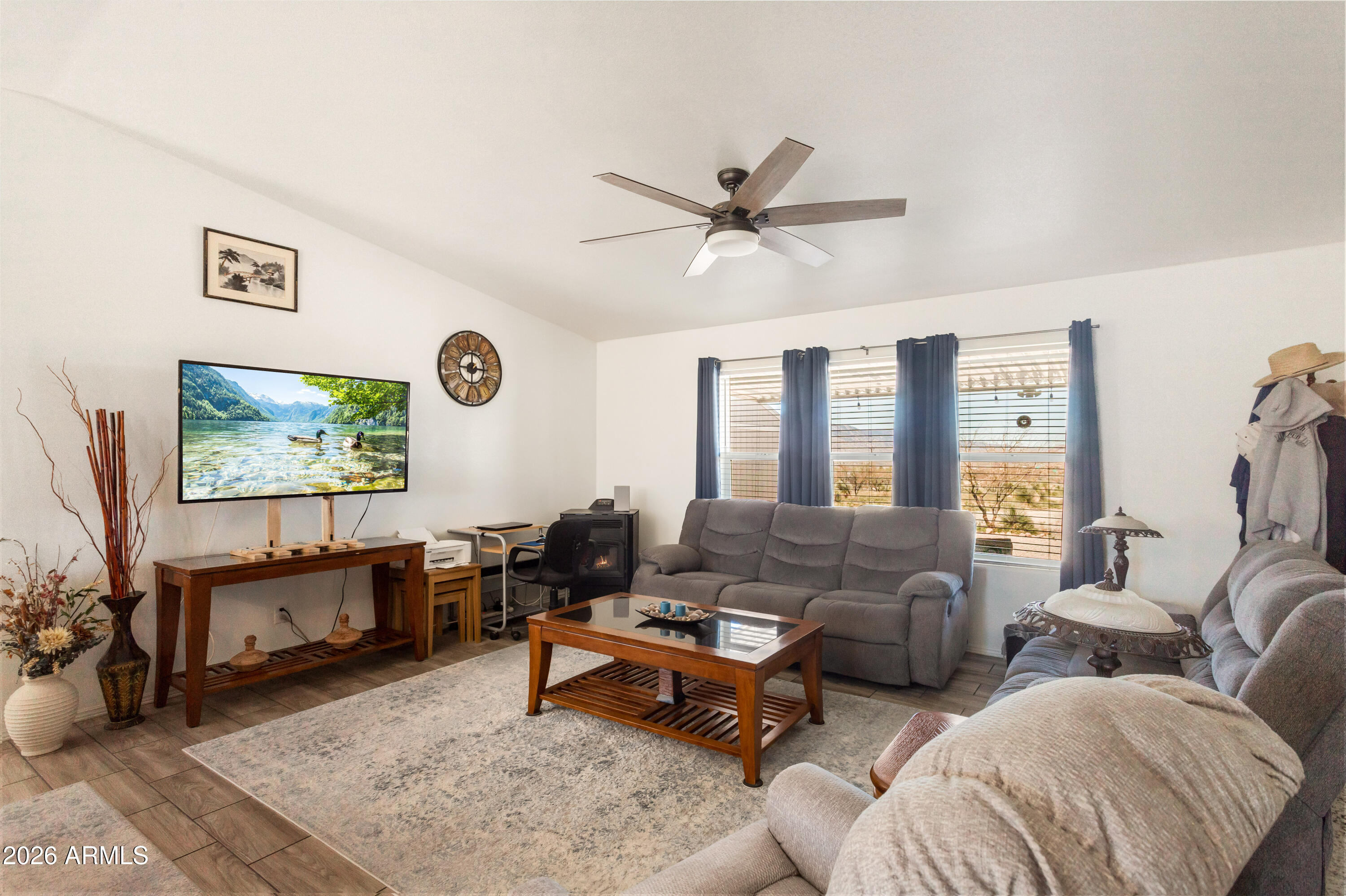 3191 West Williams Road Benson, AZ 85602 - Photo 13 of 46 a living room with furniture a rug and a large window