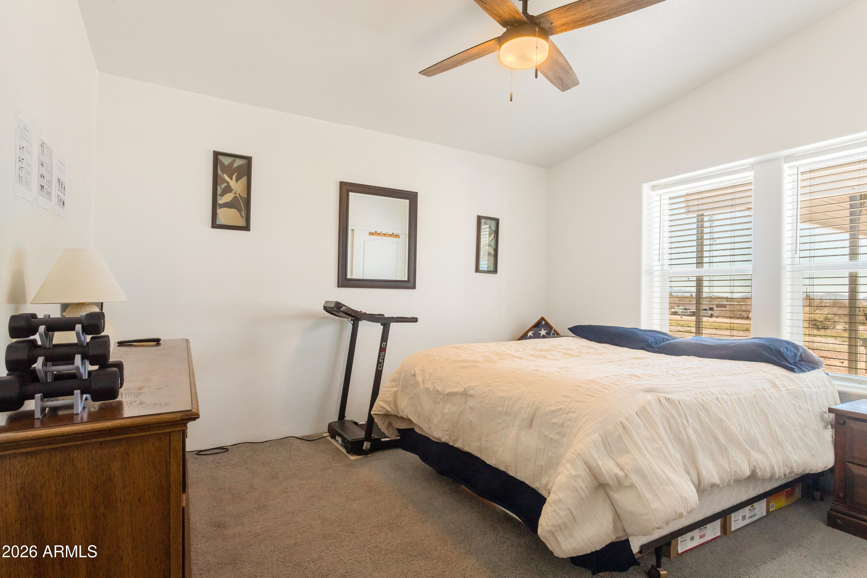 3191 West Williams Road Benson, AZ 85602 - Photo 15 of 46 a bedroom with a bed and window