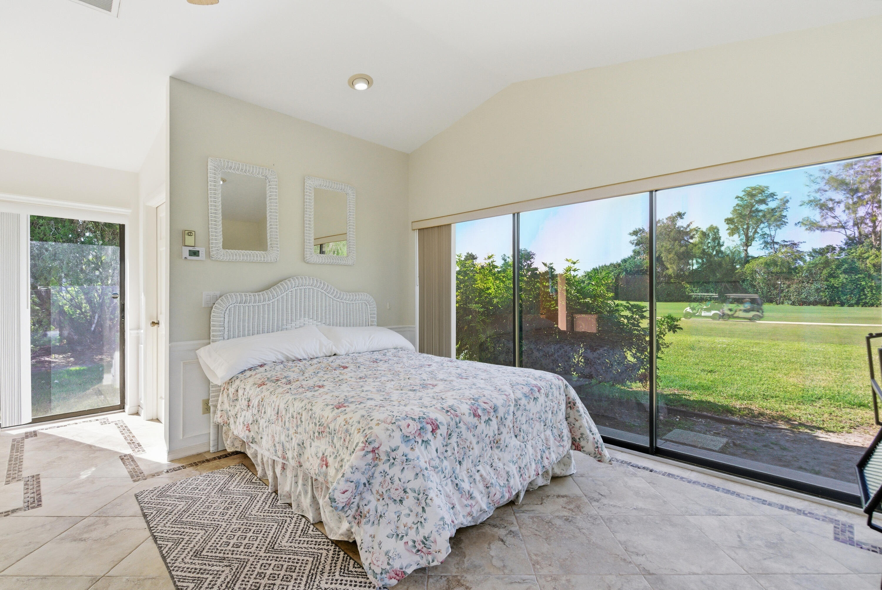 5151 Southeast Burning Tree Circle Stuart, FL 34997 - Photo 42 of 74 a bedroom with a bed and large window