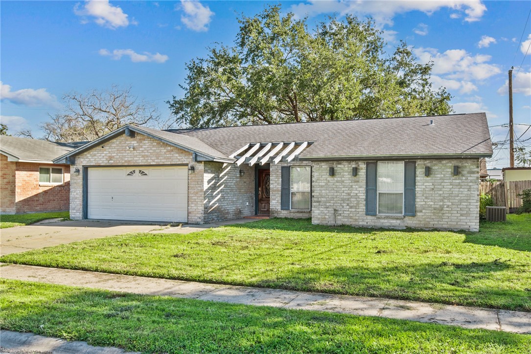 1910 Cherokee Street Corpus Christi, TX 78409 - Photo 1 of 23 a front view of a house with a yard and garage