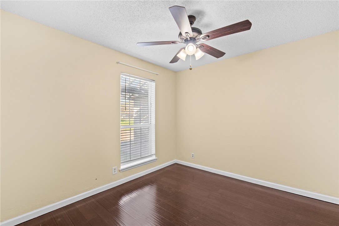 1910 Cherokee Street Corpus Christi, TX 78409 - Photo 16 of 23 an empty room with wooden floor fan and windows
