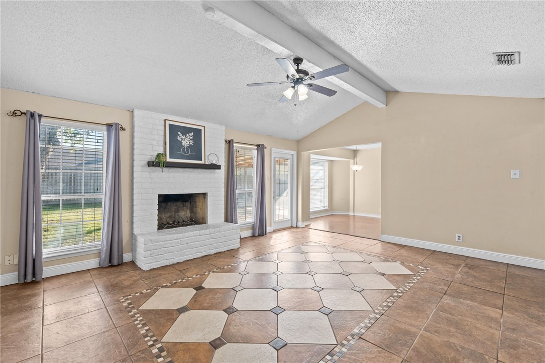 1910 Cherokee Street Corpus Christi, TX 78409 - Photo 3 of 23 a view of an empty room with a fireplace and a window