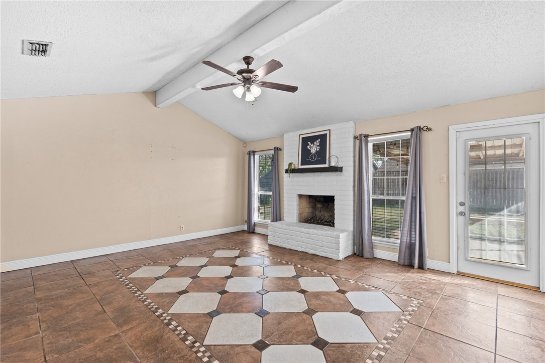 1910 Cherokee Street Corpus Christi, TX 78409 - Photo 4 of 23 a view of a livingroom with a fireplace a ceiling fan and window