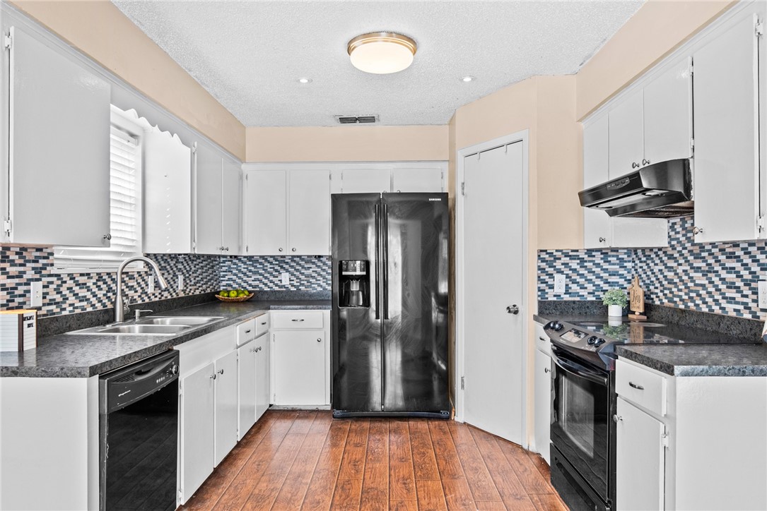 1910 Cherokee Street Corpus Christi, TX 78409 - Photo 8 of 23 a kitchen with a sink stove and refrigerator