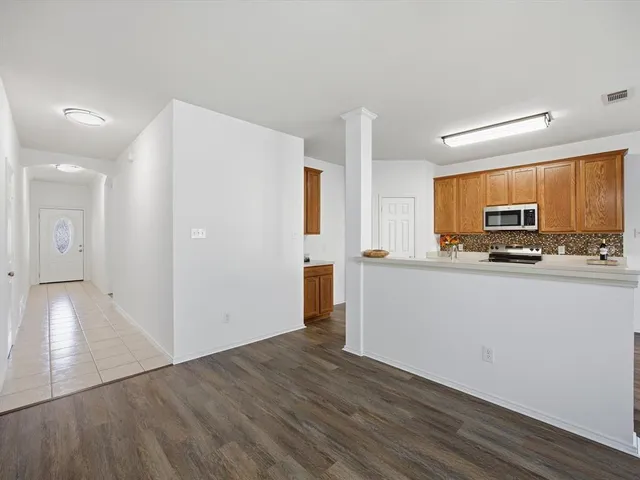 a view of a kitchen with wooden floor
