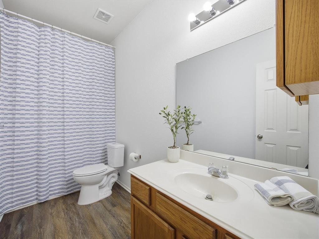 13264 Fencerow Road Fort Worth, TX 76244 - Photo 13 of 26 a bathroom with a sink toilet and vanity