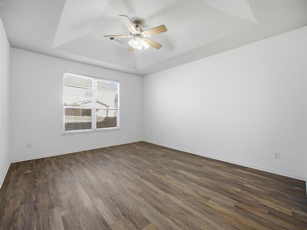 13264 Fencerow Road Fort Worth, TX 76244 - Photo 14 of 26 an empty room with wooden floor chandelier fan and windows