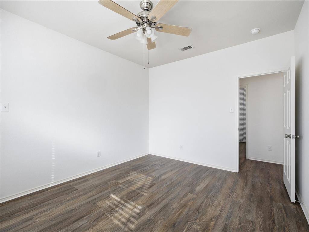 13264 Fencerow Road Fort Worth, TX 76244 - Photo 20 of 26 an empty room with wooden floor and fan