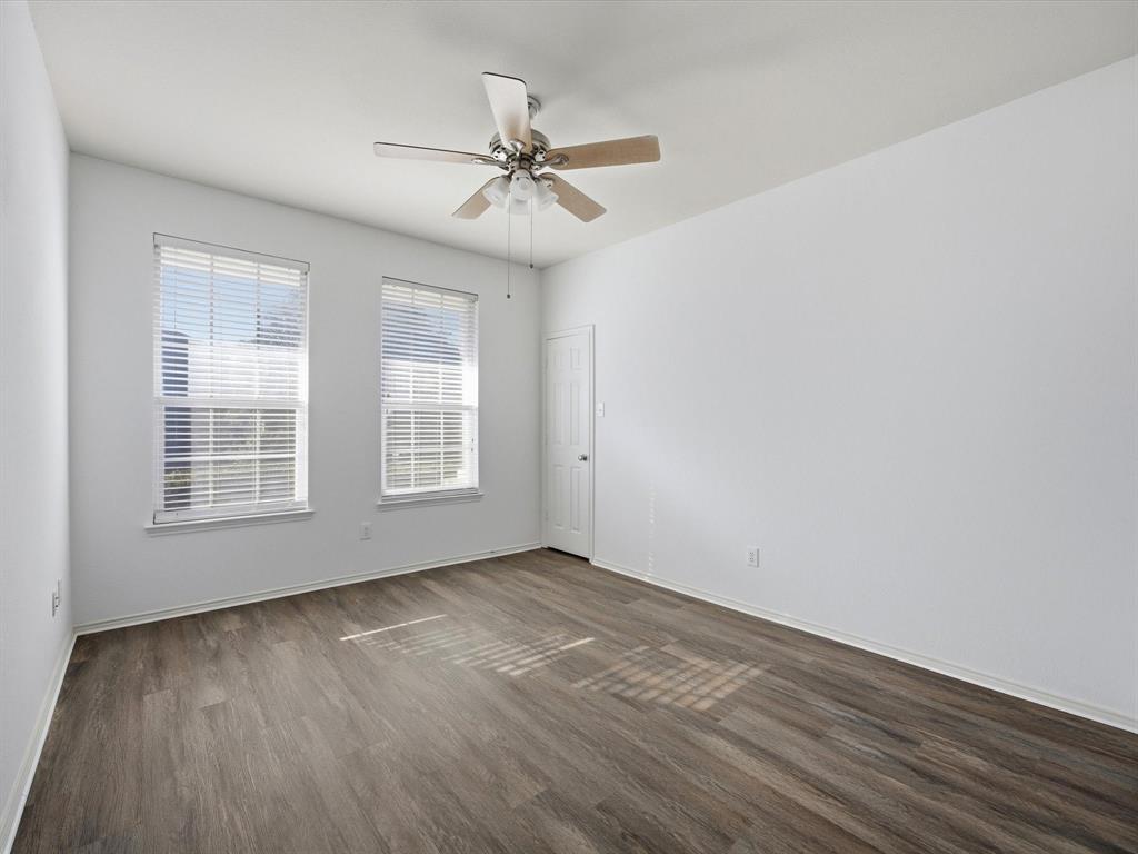 13264 Fencerow Road Fort Worth, TX 76244 - Photo 23 of 26 a view of an empty room with wooden floor and a window