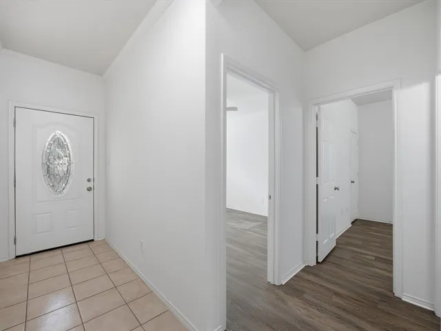 a view of hallway with wooden floor