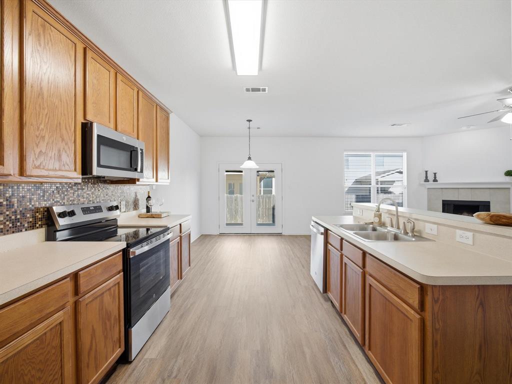 13264 Fencerow Road Fort Worth, TX 76244 - Photo 5 of 26 a kitchen with stainless steel appliances granite countertop a sink stove and refrigerator