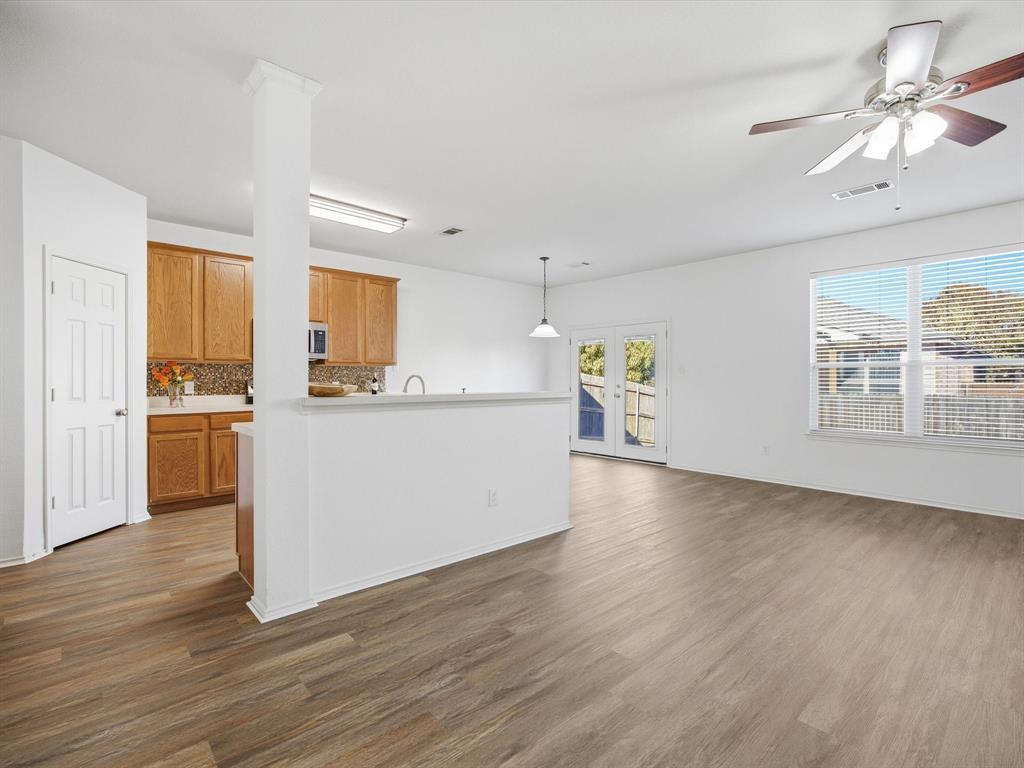 13264 Fencerow Road Fort Worth, TX 76244 - Photo 6 of 26 a view of a kitchen with furniture and wooden floor