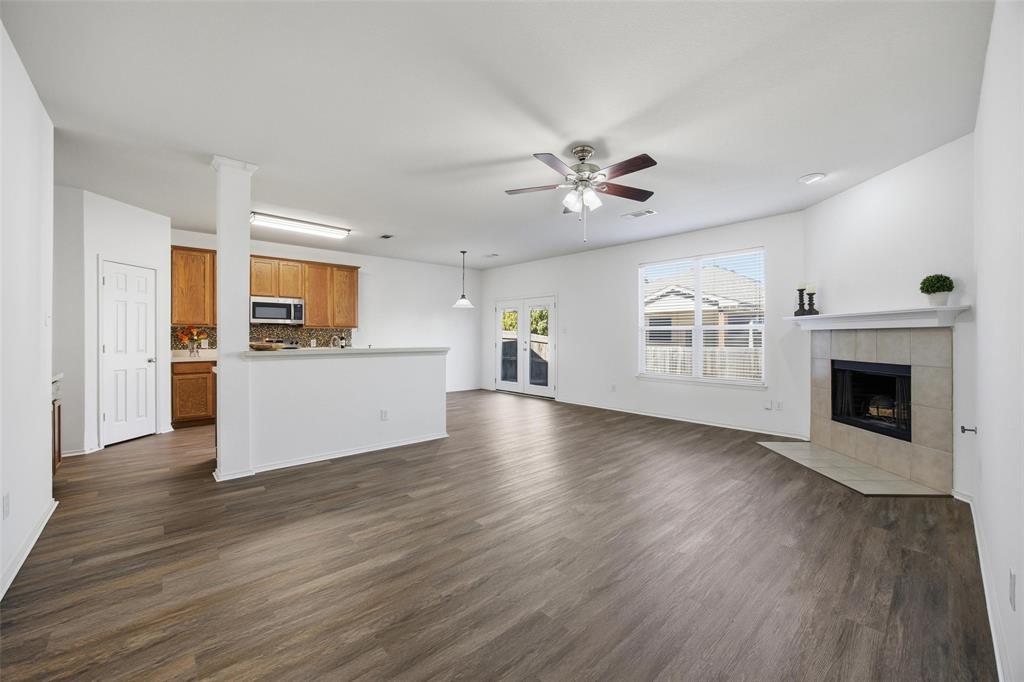 13264 Fencerow Road Fort Worth, TX 76244 - Photo 7 of 26 a view of a big room with wooden floor a kitchen view and a window