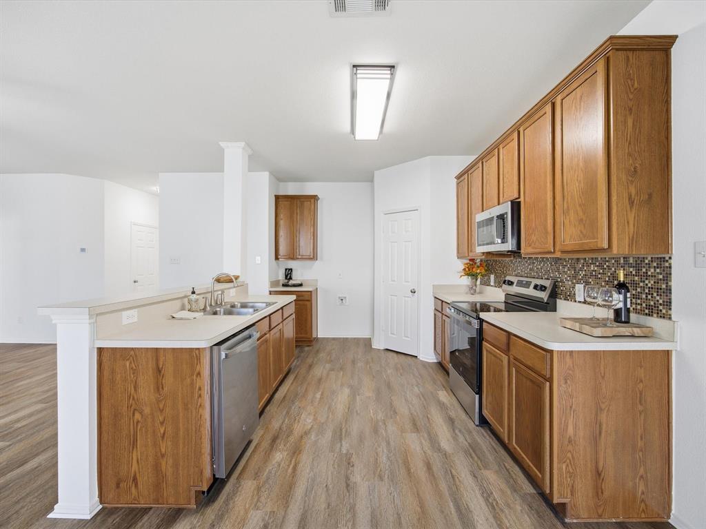 13264 Fencerow Road Fort Worth, TX 76244 - Photo 8 of 26 a kitchen with a sink stove top oven and cabinets