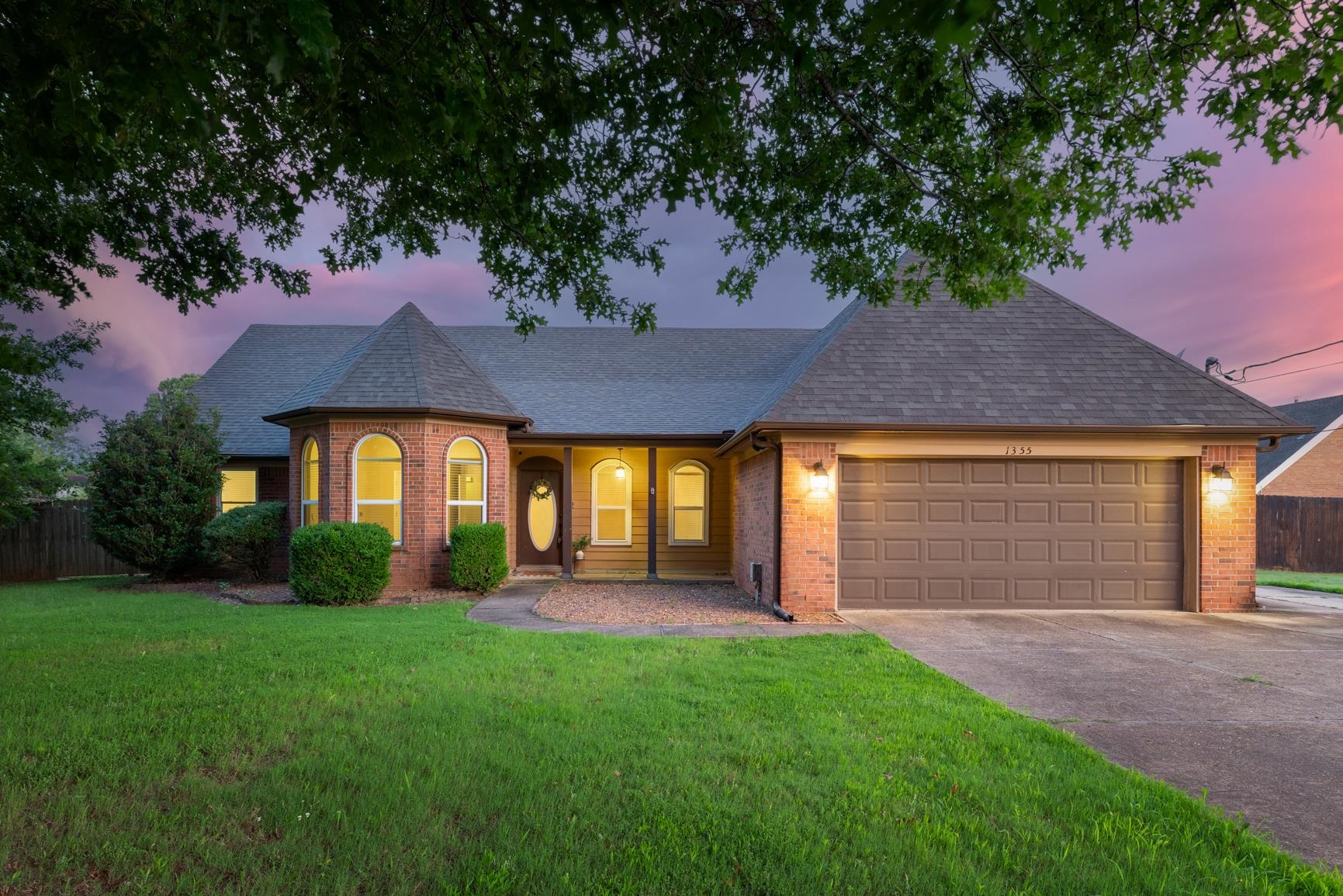 1355 Rosemark Road Atoka, TN 38004 - Photo 1 of 40 View of front of house featuring brick siding, a shingled roof, driveway, and a garage