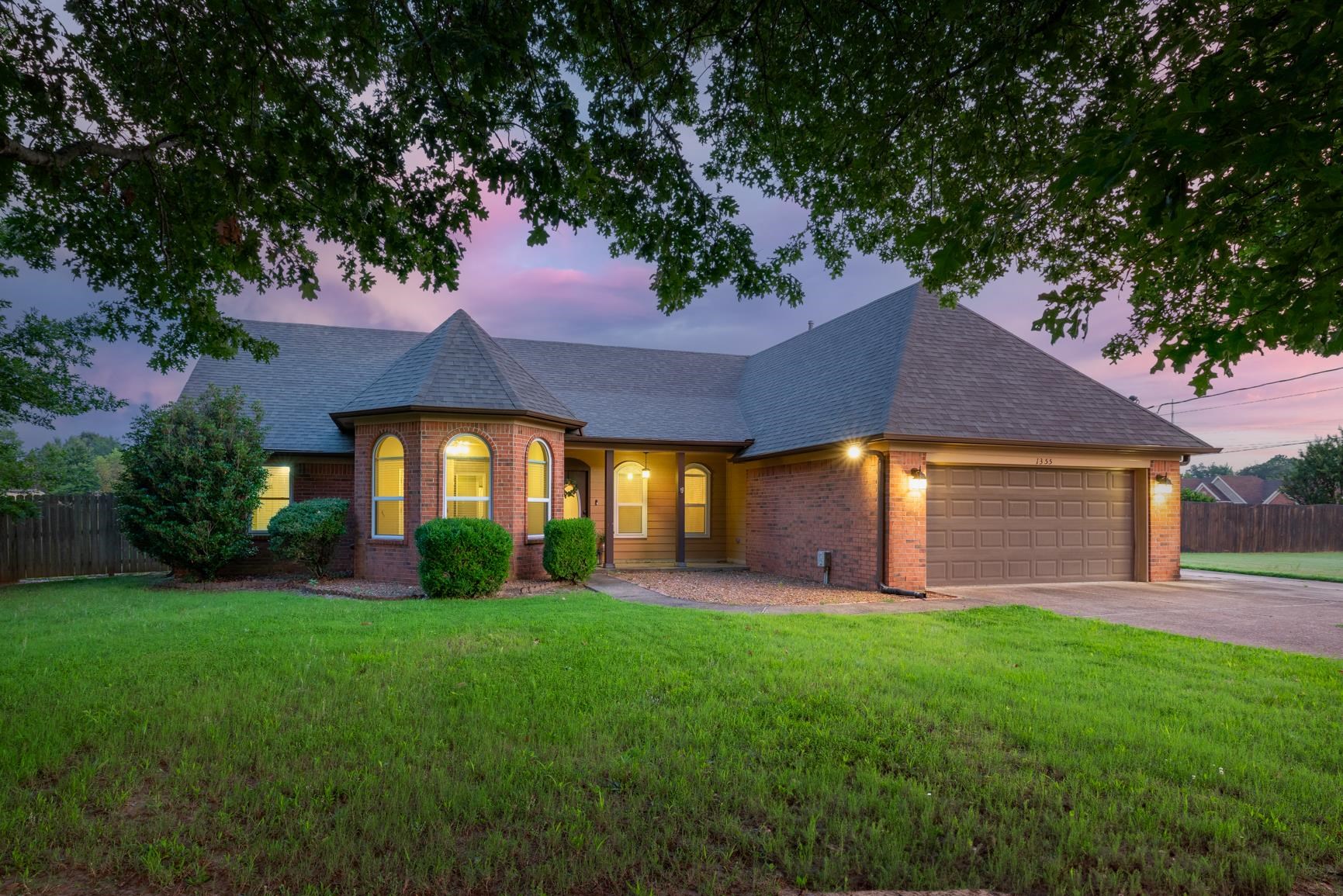 1355 Rosemark Road Atoka, TN 38004 - Photo 2 of 40 View of front of property with brick siding, roof with shingles, a garage, and concrete driveway