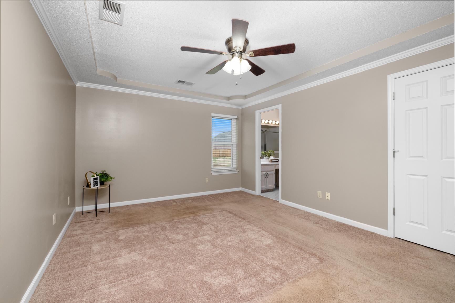 1355 Rosemark Road Atoka, TN 38004 - Photo 22 of 40 Carpeted spare room featuring baseboards, a ceiling fan, visible vents, and ornamental molding