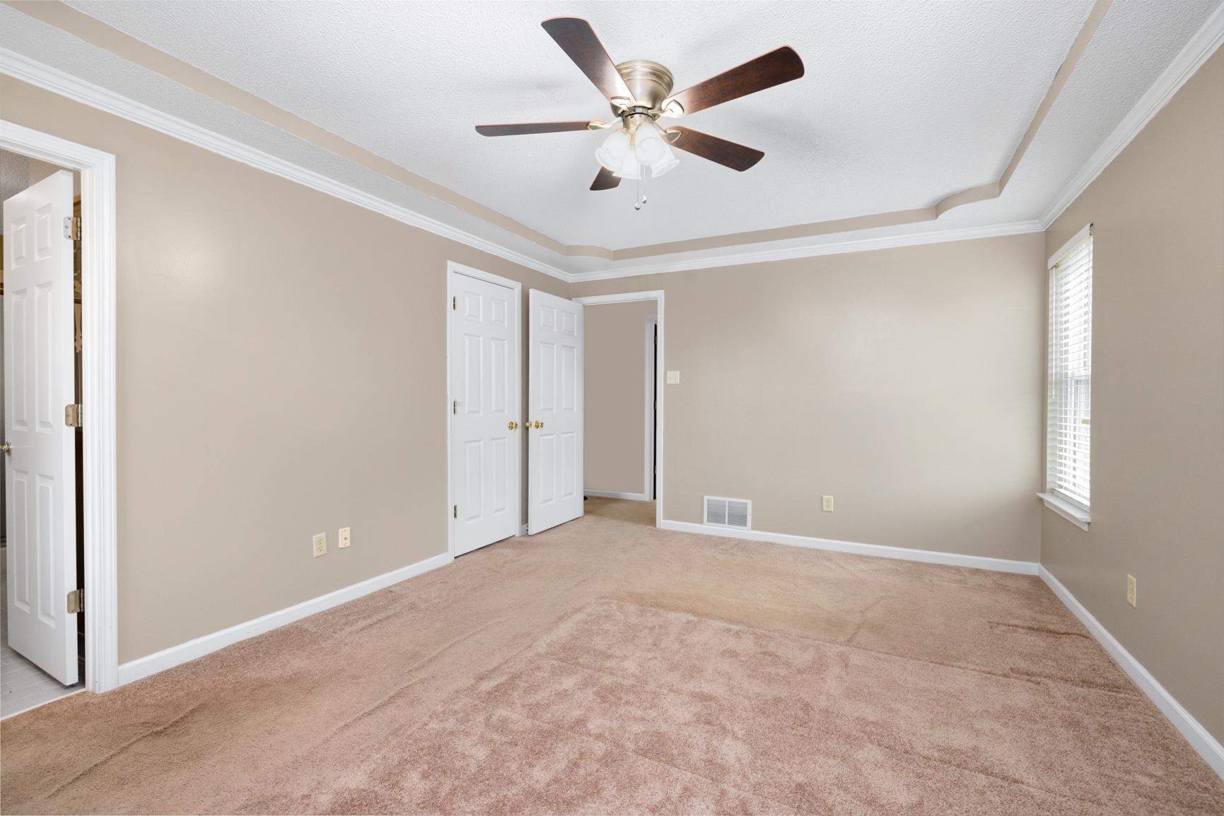 1355 Rosemark Road Atoka, TN 38004 - Photo 23 of 40 Unfurnished bedroom with visible vents, baseboards, light carpet, and crown molding