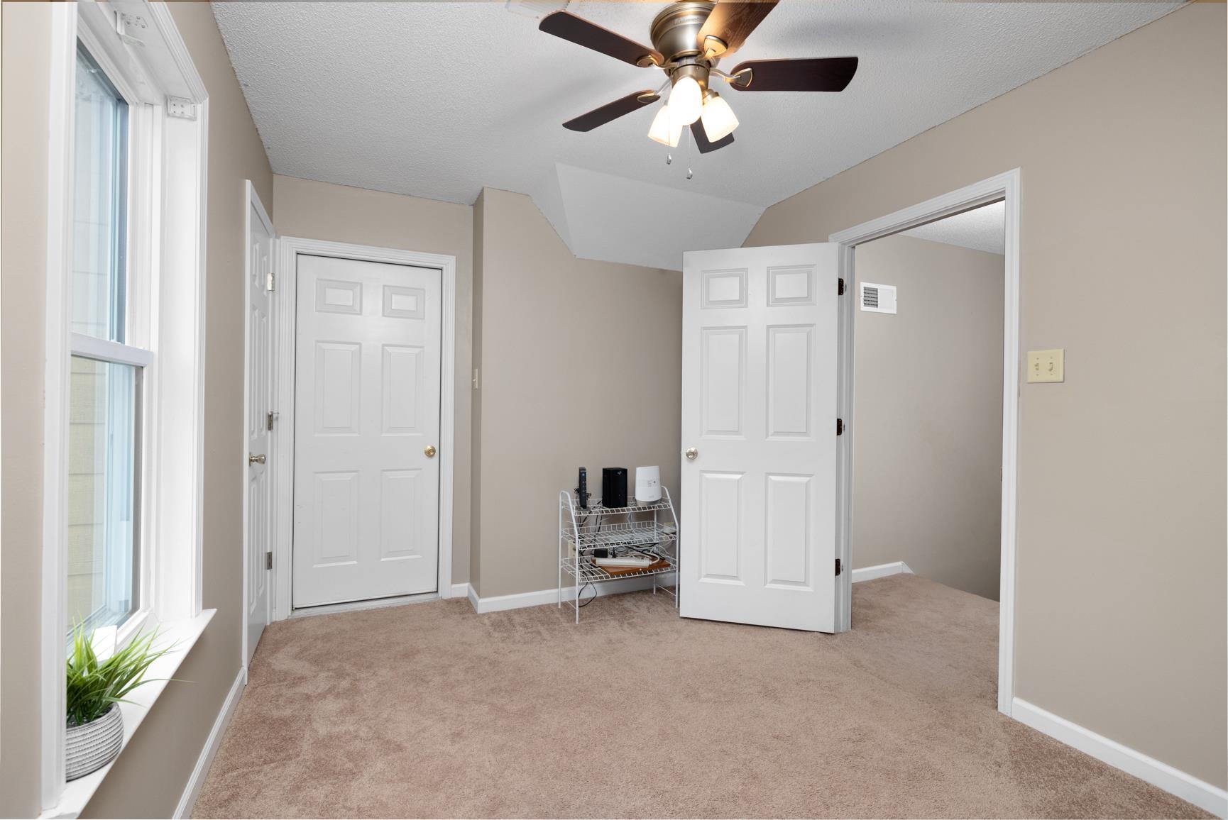 1355 Rosemark Road Atoka, TN 38004 - Photo 30 of 40 Unfurnished bedroom featuring light carpet, visible vents, and multiple windows