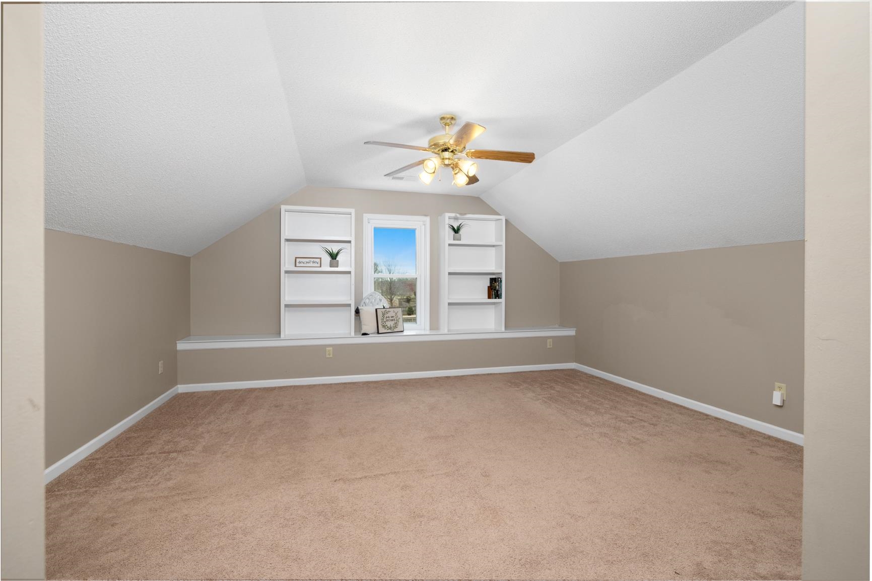 1355 Rosemark Road Atoka, TN 38004 - Photo 32 of 40 Bonus room featuring carpet flooring, baseboards, built in shelves, and a ceiling fan
