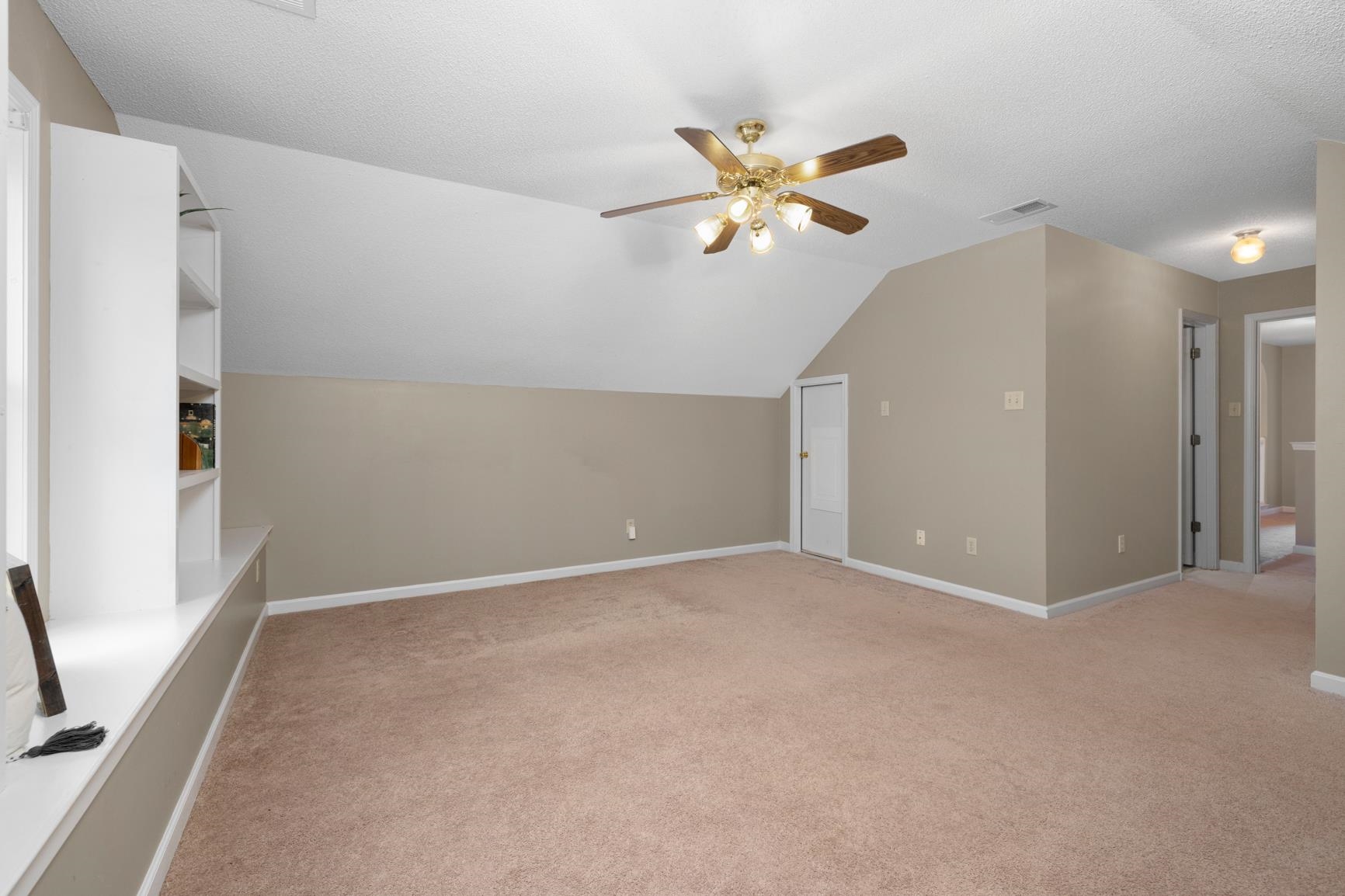 1355 Rosemark Road Atoka, TN 38004 - Photo 33 of 40 Bonus room with visible vents, baseboards, ceiling fan, light colored carpet, and vaulted ceiling