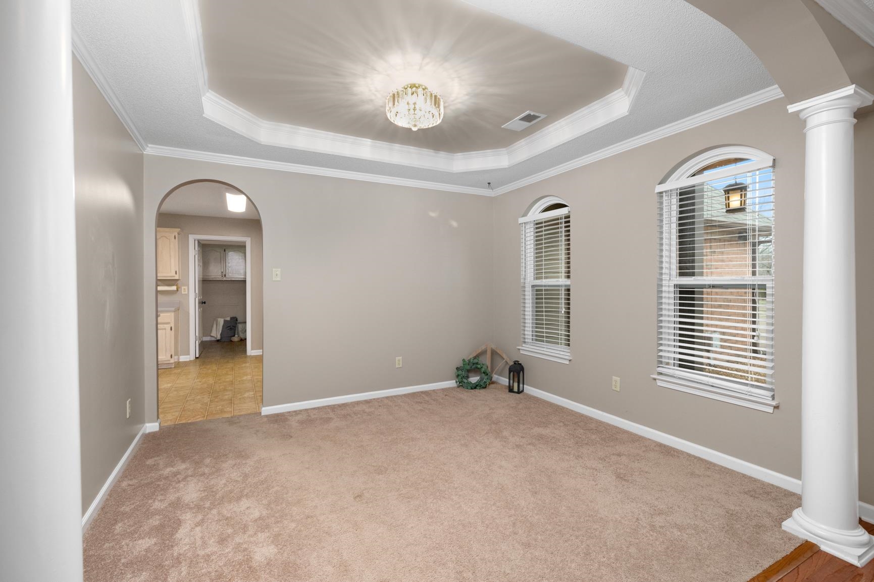 1355 Rosemark Road Atoka, TN 38004 - Photo 7 of 40 Unfurnished room with visible vents, a raised ceiling, arched walkways, and carpet flooring