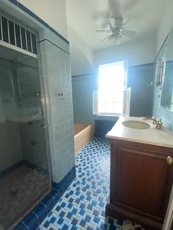 a bathroom with a sink a toilet a mirror and shower