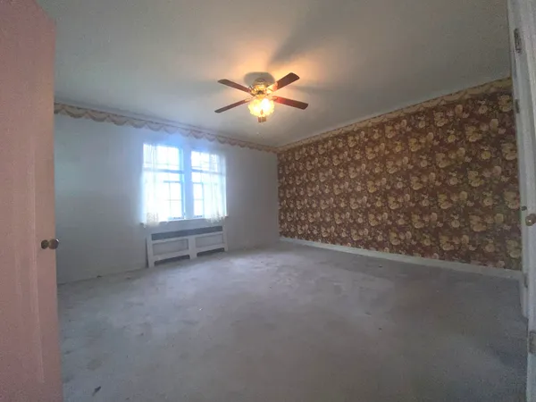 a view of an empty room with a window