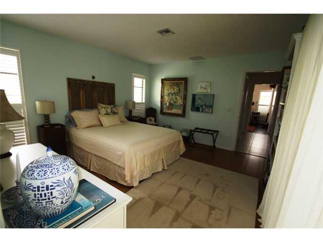 3333 Southeast Fairway East Stuart, FL 34997 - Photo 14 of 14 a bedroom with a bed mirror and window