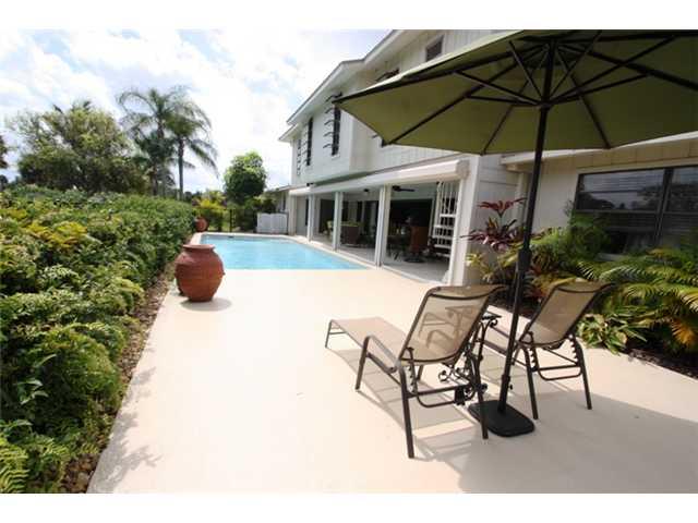 3333 Southeast Fairway East Stuart, FL 34997 - Photo 2 of 14 a view of patio with chairs and table under an umbrella