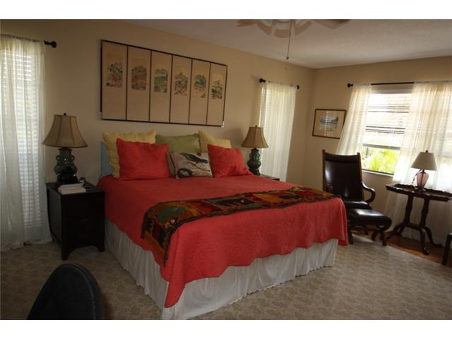 3333 Southeast Fairway East Stuart, FL 34997 - Photo 7 of 14 a bedroom with a bed and wooden floor