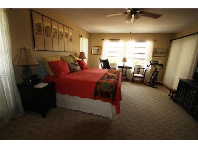 3333 Southeast Fairway East Stuart, FL 34997 - Photo 8 of 14 a bedroom with a bed and a flat tv screen
