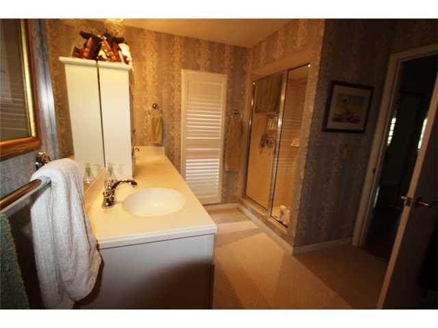 3333 Southeast Fairway East Stuart, FL 34997 - Photo 9 of 14 a bathroom with a sink a mirror and shower