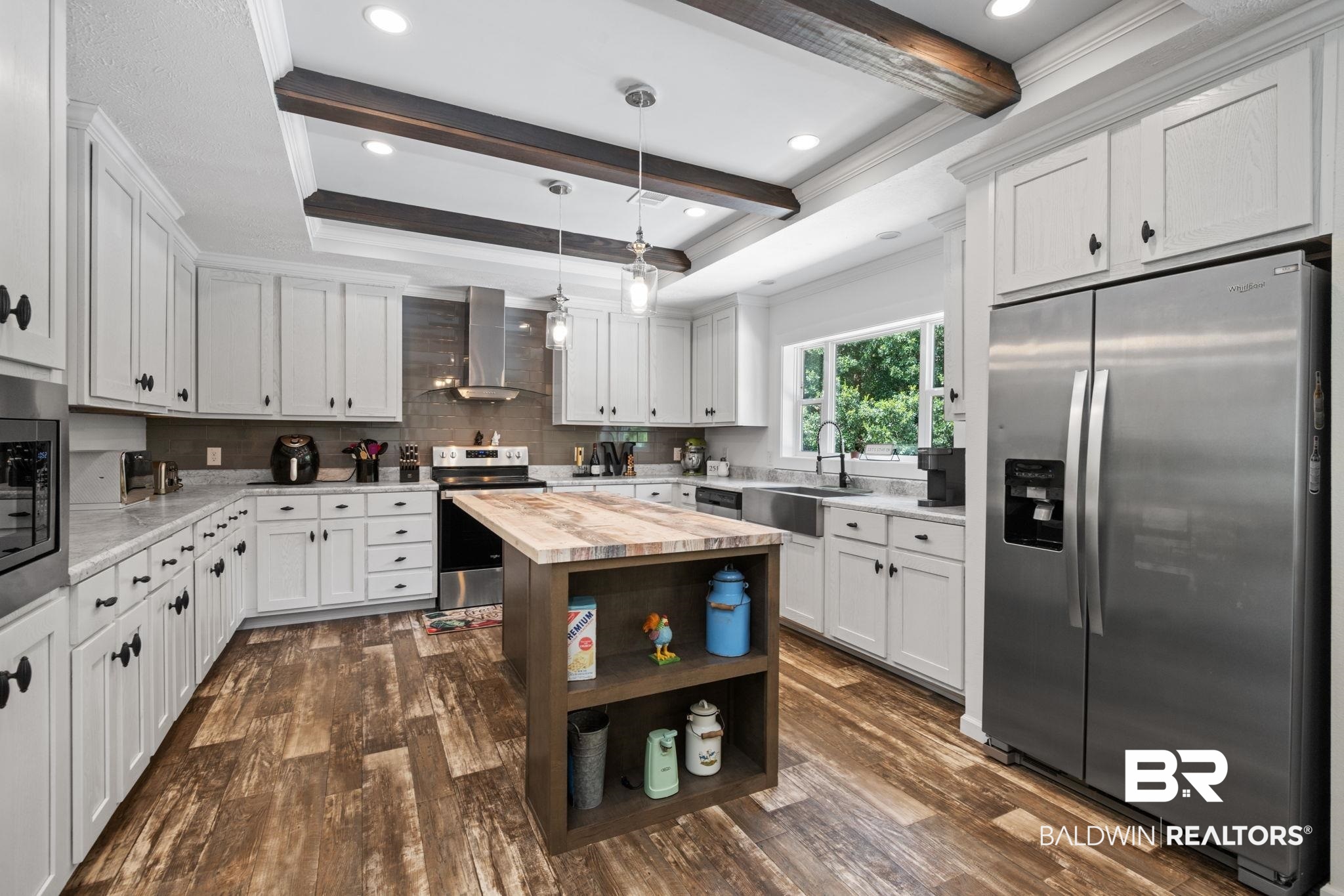 10703 South Ridge Drive Semmes, AL 36575 - Photo 15 of 37 Kitchen featuring stainless steel appliances, wall chimney range hood, wood counters, dark wood-style flooring, and beam ceiling