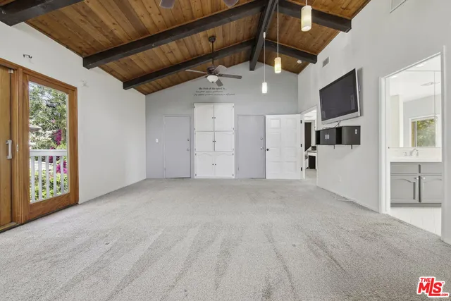 a large white kitchen with a large window