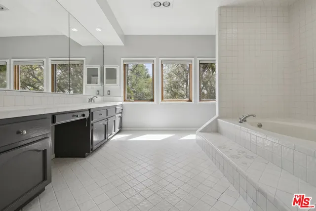 a spacious bathroom with bathtub and shower