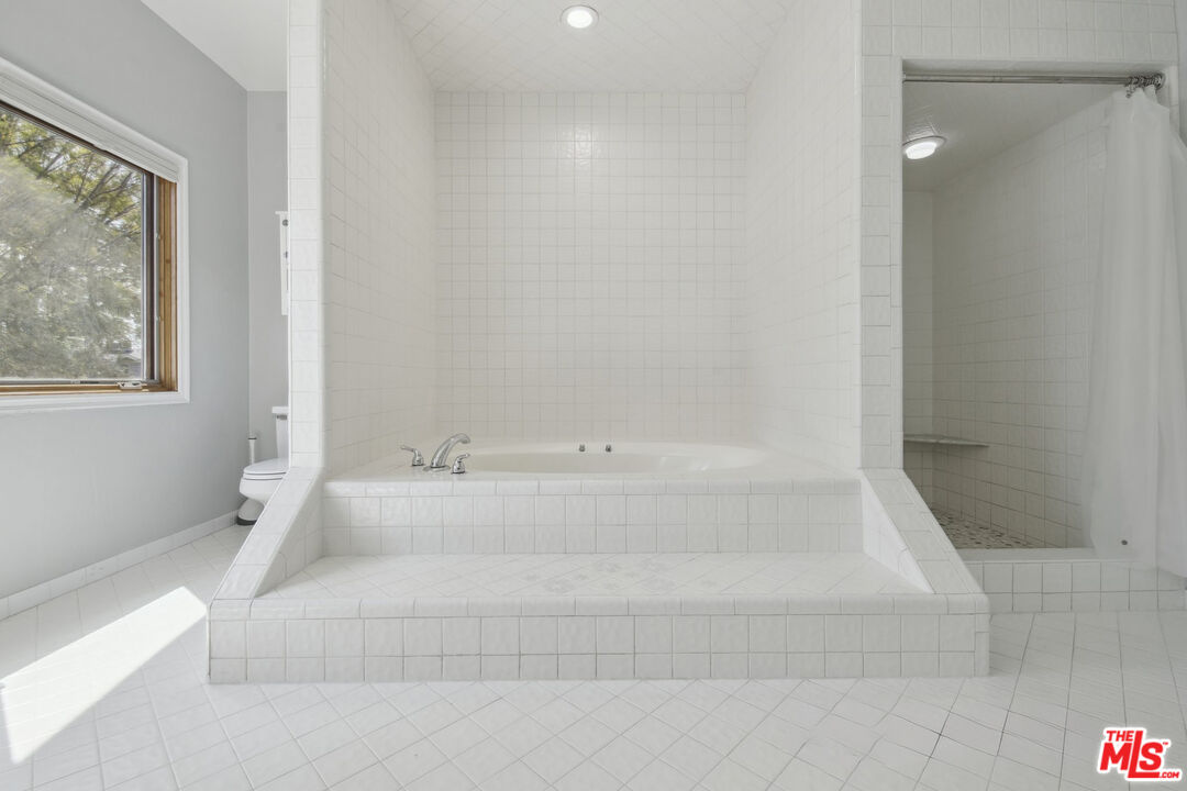 5527 Columbus Avenue Sherman Oaks, CA 91411 - Photo 13 of 29 a spacious bathroom with bathtub and shower