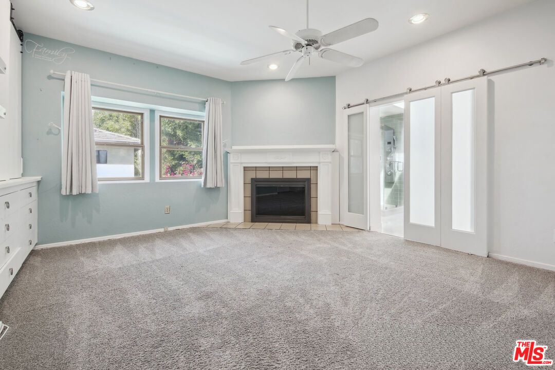 5527 Columbus Avenue Sherman Oaks, CA 91411 - Photo 14 of 29 an empty room with windows and fireplace