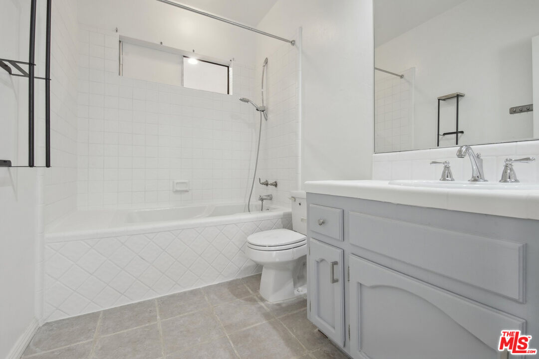 5527 Columbus Avenue Sherman Oaks, CA 91411 - Photo 16 of 29 a bathroom with a sink a toilet and a bathtub