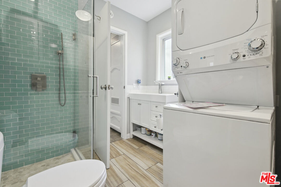 5527 Columbus Avenue Sherman Oaks, CA 91411 - Photo 24 of 29 a bathroom with a toilet a sink and shower
